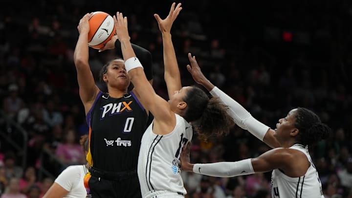 Aug 22, 2025; Phoenix, Arizona, USA; Phoenix Mercury forward Satou Sabally (0) shoots over Golden State Valkyries center Iliana Rupert (12) and center Temi Fagbenle (14) in the second half at Footprint Center. Mandatory Credit: Rick Scuteri-Imagn Images