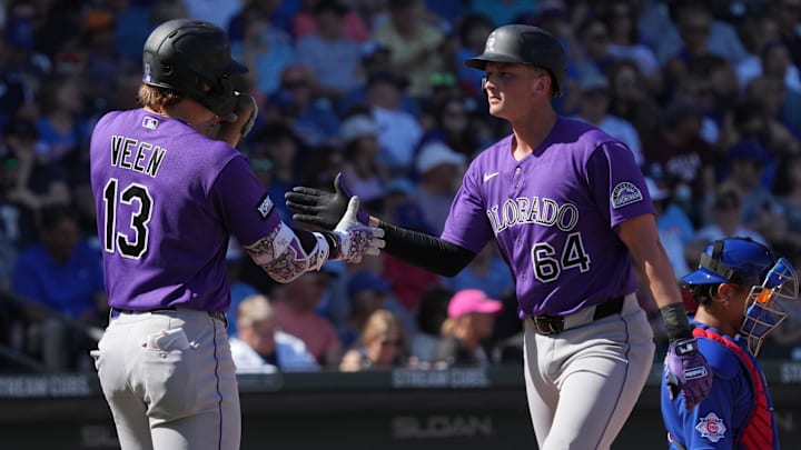 Feb 25, 2026; Mesa, Arizona, USA; Colorado Rockies first baseman T.J. Rumfield (64) celebrates with left fielder Zac Veen after hitting a solo home run against the Chicago Cubs in the second inning at Sloan Park. Mandatory Credit: Rick Scuteri-Imagn Images Feb 25, 2026; Mesa, Arizona, USA; Colorado Rockies first baseman T.J. Rumfield (64) celebrates with left fielder Zac Veen after hitting a solo home run against the Chicago Cubs in the second inning at Sloan Park. Mandatory Credit: Rick Scuteri-Imagn Images