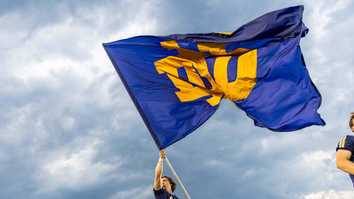 Sep 20, 2025; South Bend, Indiana, USA; A Notre Dame Fighting Irish cheerleader waves a flag after scoring on the Purdue Boilermakers during the second half at Notre Dame Stadium. Sep 20, 2025; South Bend, Indiana, USA; A Notre Dame Fighting Irish cheerleader waves a flag after scoring on the Purdue Boilermakers during the second half at Notre Dame Stadium.
