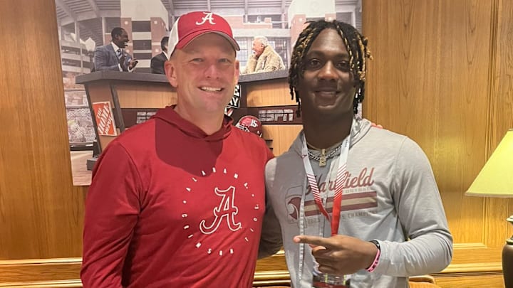 Bralan Womack poses with Alabama coach Kalen DeBoer