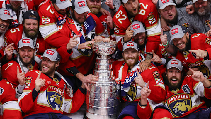 Jun 24, 2024; Sunrise, Florida, USA; The Florida Panthers pose with the cup for a team photo after winning game seven of the 2024 Stanley Cup Final against the Edmonton Oilers at Amerant Bank Arena. Mandatory Credit: Sam Navarro-Imagn Images