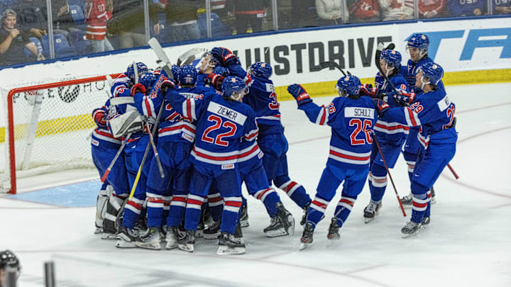 Aug 3, 2024; Plymouth, MI, USA; Team USA celebrates their O.T. shootout win over Canada during the of the 2024 World Junior Summer Showcase at USA Hockey Arena. Mandatory Credit: David Reginek-Imagn Images