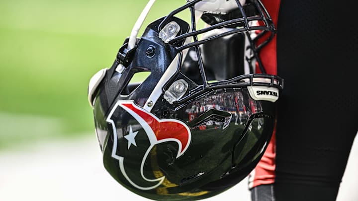 Sep 22, 2024; Minneapolis, Minnesota, USA; A Houston Texans player holds onto his helmet from the sideline during the game against the Minnesota Vikings at U.S. Bank Stadium. Mandatory Credit: Jeffrey Becker-Imagn Images
