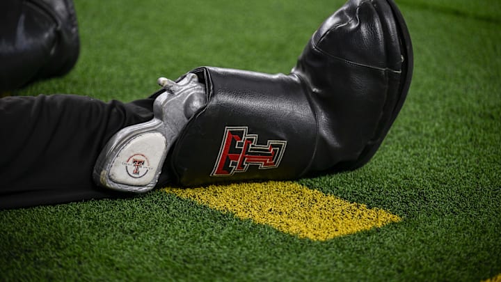 A view of the boots and pistol of the Texas Tech Red Raiders mascot during the game between the Red Raiders and the Cougars at AT&T Stadium. A view of the boots and pistol of the Texas Tech Red Raiders mascot during the game between the Red Raiders and the Cougars at AT&T Stadium.