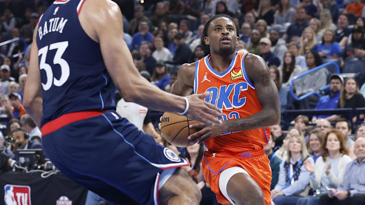 Nov 11, 2024; Oklahoma City, Oklahoma, USA; Oklahoma City Thunder guard Cason Wallace (22) drives to the basket against Los Angeles Clippers forward Nicolas Batum (33) during the second quarter at Paycom Center. Mandatory Credit: Alonzo Adams-Imagn Images