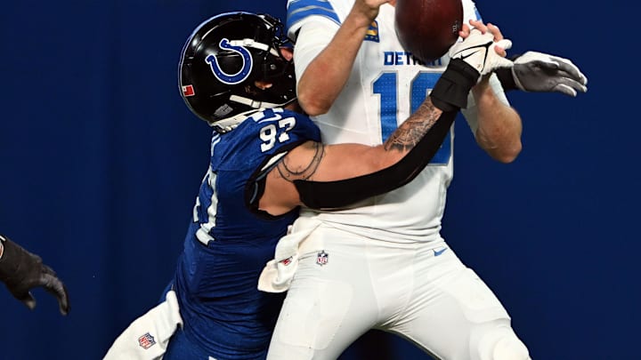 Nov 24, 2024; Indianapolis, Indiana, USA; Detroit Lions quarterback Jared Goff (16) fumbles the ball when hit by Indianapolis Colts defensive end Laiatu Latu (97) during the second half at Lucas Oil Stadium. Mandatory Credit: Marc Lebryk-Imagn Images