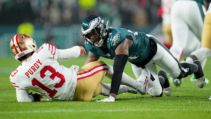 San Francisco 49ers quarterback Brock Purdy (L) is tackled by Philadelphia Eagles edge Josh Sweat (R)