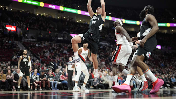 Mar 22, 2024; Portland, Oregon, USA; LA Clippers center Mason Plumlee (44) shoots the ball as Portland Trail Blazers center Duop Reath (26) looks on during the second half at Moda Center. Mandatory Credit: Soobum Im-Imagn Images