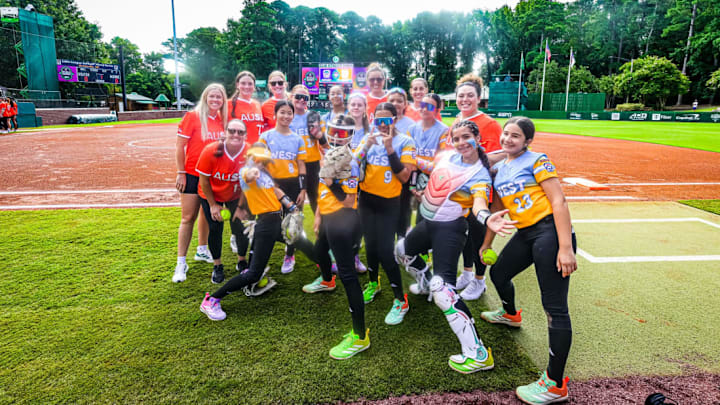 Members of the West Region pose with Athletes Unlimited All-Star Cup players ahead of the opening game on day three of the tournament. Members of the West Region pose with Athletes Unlimited All-Star Cup players ahead of the opening game on day three of the tournament.