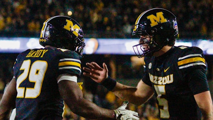 Nov 15, 2025; Columbia, Missouri, USA; Missouri Tigers running back Ahmad Hardy celebrates with quarterback Matt Zollers after scoring one of his three touchdowns on the night.