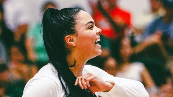 Miami Volleyball Celebrating a victory with smiles on the face.