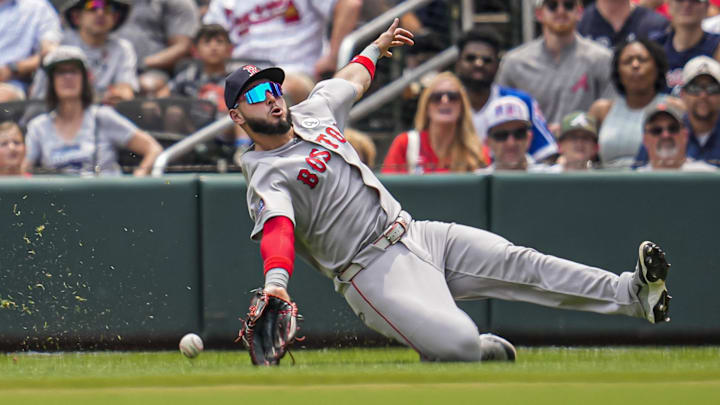 Jun 1, 2025; Cumberland, Georgia, USA; Boston Red Sox right fielder Wilmer Abreu (52) tries to make a sliding catch against the Atlanta Braves at Truist Park. Mandatory Credit: Dale Zanine-Imagn Images