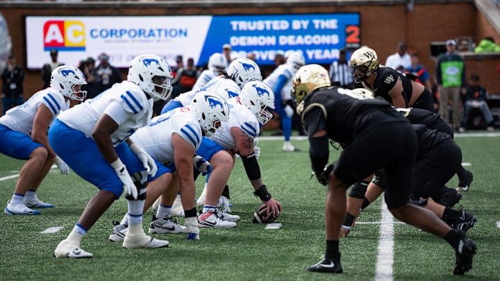 The Wake Forest defense prepares to make a stop against the SMU Mustangs