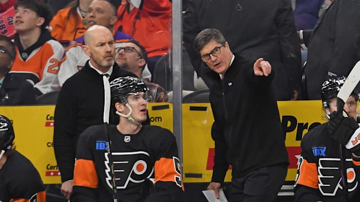Mar 27, 2025; Philadelphia, Pennsylvania, USA; Philadelphia Flyers interim head coach Brad Shaw and assistant coach Darryl Williams talk with defenseman Egor Zamula (5) against the Montreal Canadiens during the second period at Wells Fargo Center. Mandatory Credit: Eric Hartline-Imagn Images