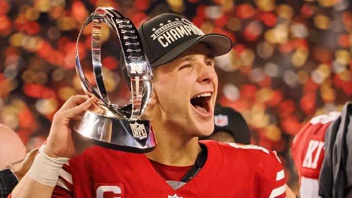Jan 28, 2024; Santa Clara, California, USA; San Francisco 49ers quarterback Brock Purdy (13) holds the George Halas Trophy while after winning the NFC Championship football game against the Detroit Lions at Levi's Stadium. Mandatory Credit: Kelley L Cox-USA TODAY Sports