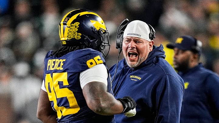 Michigan defensive line coach Lou Esposito talks to defensive lineman Trey Pierce (95) during the second half against Michigan State at Michigan Stadium in Ann Arbor on Saturday, Oct. 26, 2024.
