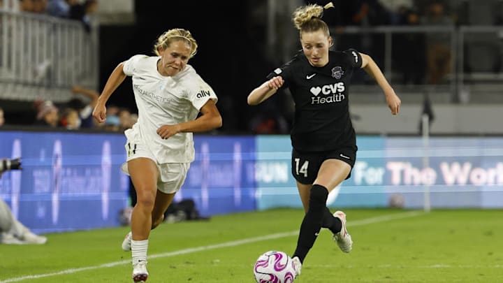 Oct 15, 2023; Washington, District of Columbia, USA; North Carolina Courage forward Brittany Ratcliffe (11) and Washington Spirit defender Gabrielle Carle (14) chase the ball during the second half at Audi Field. Mandatory Credit: Geoff Burke-USA TODAY Sports
