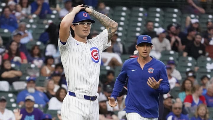 Sep 22, 2024; Chicago, Illinois, USA; Chicago Cubs pitcher Ethan Roberts (39) and manager Craig Counsell (30) argue a call against the Washington Nationals during the eighth inning at Wrigley Field. 
