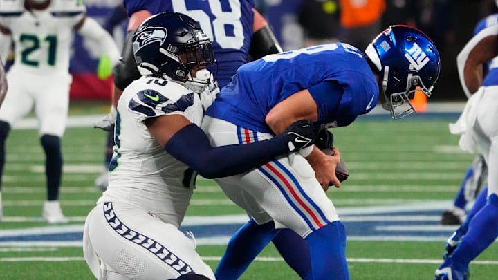 Oct 2, 2023; East Rutherford, New Jersey, USA; New York Giants quarterback Daniel Jones (8) is sacked by Seattle Seahawks linebacker Uchenna Nwosu (10) in the second half at MetLife Stadium.