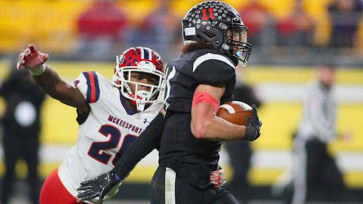 Aliquippa's Cameron Lindsey (11) pushes away from McKeesport's Kemon Spell (20) during the first half of the WPIAL 4A Championship game Friday evening at Acrisure Stadium in Pittsburgh, PA. Aliquippa's Cameron Lindsey (11) pushes away from McKeesport's Kemon Spell (20) during the first half of the WPIAL 4A Championship game Friday evening at Acrisure Stadium in Pittsburgh, PA.