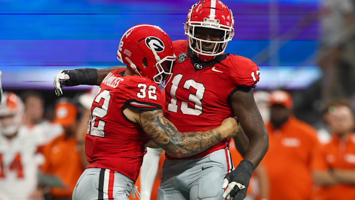 Georgia Bulldogs defensive lineman Mykel Williams celebrates after a tackle with linebacker Chaz Chambliss.