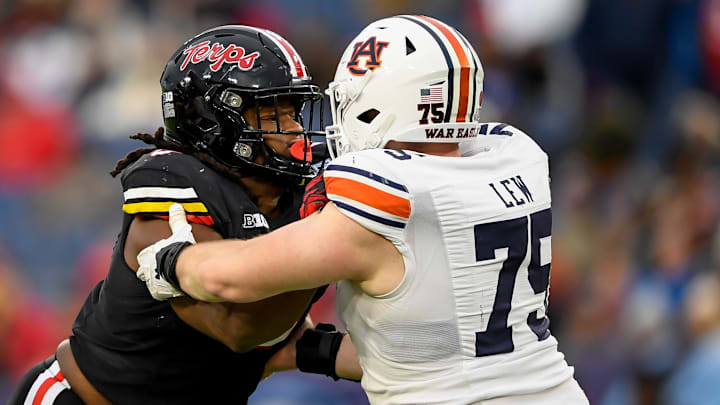 Dec 30, 2023; Nashville, TN, USA;  Maryland Terrapins defensive lineman Christian Teague (91) rushes as Auburn Tigers offensive lineman Connor Lew (75) defends during the second half at Nissan Stadium. Mandatory Credit: Steve Roberts-Imagn Images