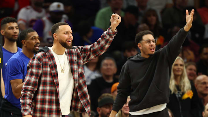 Feb 5, 2026; Phoenix, Arizona, USA; Golden State Warriors guard Stephen Curry (left) and brother Seth Curry react against the Phoenix Suns in the second half at Mortgage Matchup Center. Mandatory Credit: Mark J. Rebilas-Imagn Images