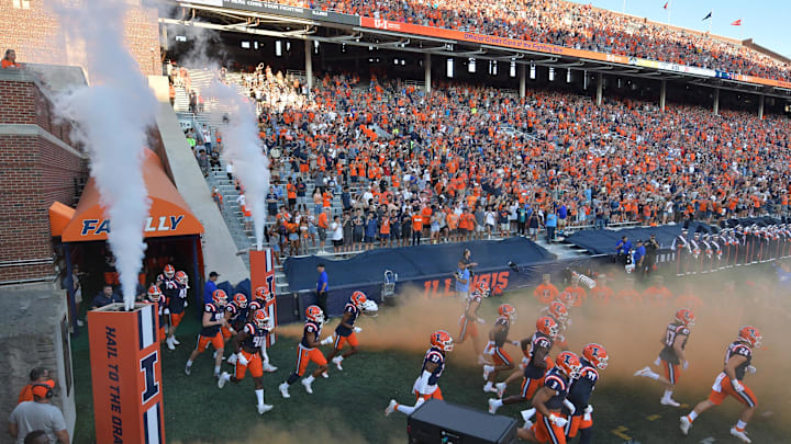 Sep 2, 2023; Champaign, Illinois, USA; The Illinois Fighting Illini take the field before a game against the Toledo Rockets at Memorial Stadium. Mandatory Credit: Ron Johnson-Imagn Images Sep 2, 2023; Champaign, Illinois, USA; The Illinois Fighting Illini take the field before a game against the Toledo Rockets at Memorial Stadium. Mandatory Credit: Ron Johnson-Imagn Images
