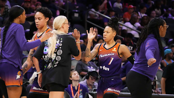 Phoenix Mercury guard Sophie Cunningham (9) greets guard Sug Sutton (1) during a time out against the Washington Mystics at Footprint Center in Phoenix on Sept. 5, 2023.
