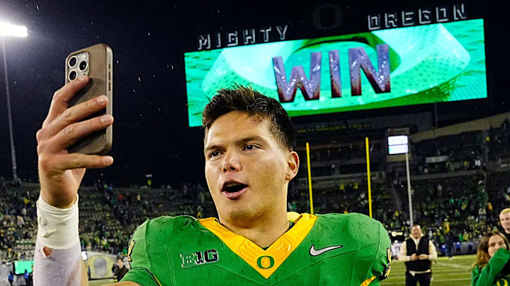 Oregon quarterback Dillon Gabriel posts a video on social media on his way off the field after defeating Maryland at Autzen Stadium Saturday, Nov. 9, 2024.