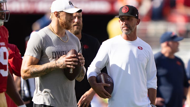 Aug 19, 2023; Santa Clara, California, USA;  San Francisco 49ers tight end George Kittle (85) , left, speaks with head coach Kyle Shanahan before the start of the first quarter against the Denver Broncos at Levi's Stadium. Mandatory Credit: Stan Szeto-Imagn Images