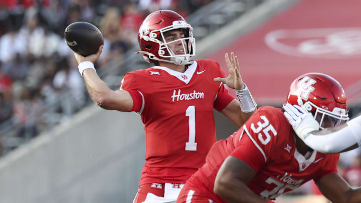 Nov 22, 2025; Houston, Texas, USA; Houston Cougars quarterback Conner Weigman (1) throws a pass for a touchdown during the second quarter against the TCU Horned Frogs at TDECU Stadium. Mandatory Credit: Troy Taormina-Imagn Images