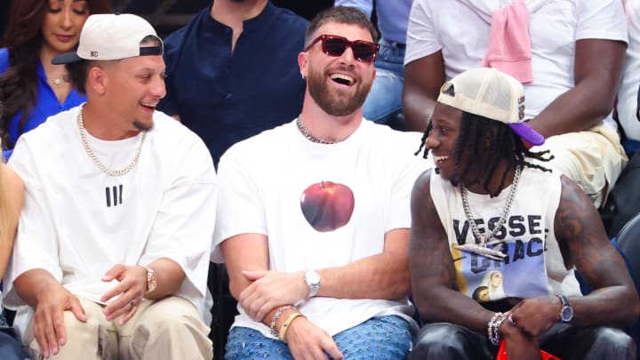 May 26, 2024; Dallas, Texas, USA; Kansas City Chiefs quarterback Patrick Mahomes II laughs with tight end Travis Kelce and wide receiver Marquis Hollywood Brown during the game between the Dallas Mavericks and Minnesota Timberwolves during game three of the western conference finals for the 2024 NBA playoffs at American Airlines Center. Mandatory Credit: Kevin Jairaj-USA TODAY Sports