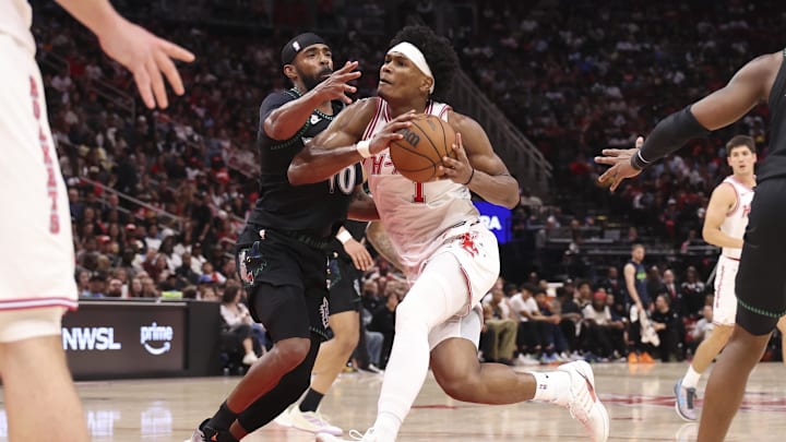 Apr 10, 2026; Houston, Texas, USA; Houston Rockets guard/forward Amen Thompson (1) drives with the ball as Minnesota Timberwolves guard Mike Conley (10) defends during the third quarter at Toyota Center. Mandatory Credit: Troy Taormina-Imagn Images