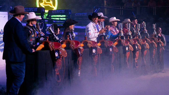 Cowboys and cowgirls with their trophies and saddles at the CINCH Playoffs Finals in Sioux Falls, S.D.