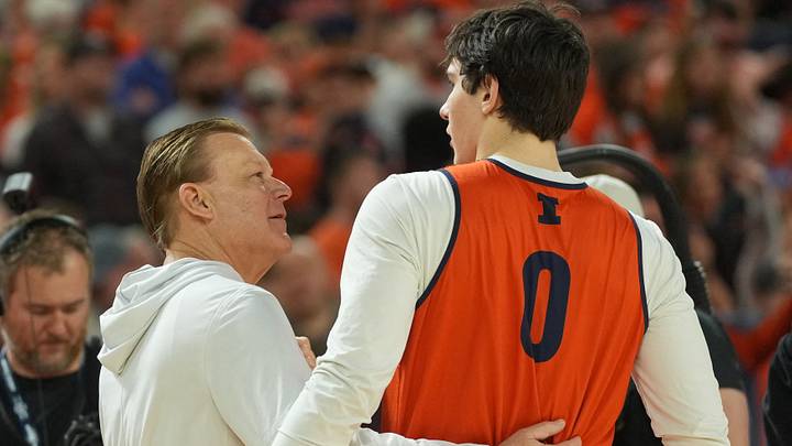 Apr 3, 2026; Indianapolis, IN, USA; Illinois Fighting Illini head coach Brad Underwood talks with forward David Mirkovic (0) during a practice session ahead of the Final Four of the men's 2026 NCAA Tournament at Lucas Oil Stadium. Mandatory Credit: Robert Deutsch-Imagn Images