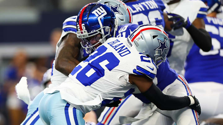 Dallas Cowboys cornerback DaRon Bland (26) tackles New York Giants running back Saquon Barkley (26) in 2023. Dallas Cowboys cornerback DaRon Bland (26) tackles New York Giants running back Saquon Barkley (26) in 2023.