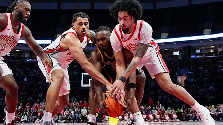 Ohio State Buckeyes center Christoph Tilly (13) and forward Devin Royal (21) fight for a loose ball with USC Trojans guard Kam Woods (13) during the first half of the NCAA men's basketball game at the Schottenstein Center on Feb. 11, 2026.
