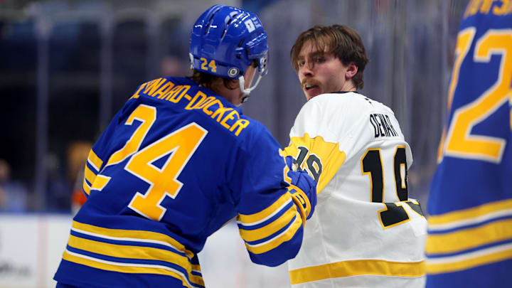 Mar 27, 2025; Buffalo, New York, USA;  Buffalo Sabres defenseman Jacob Bernard-Docker (24) and Pittsburgh Penguins center Connor Dewar (19) fight during the third period at KeyBank Center. Mandatory Credit: Timothy T. Ludwig-Imagn Images
