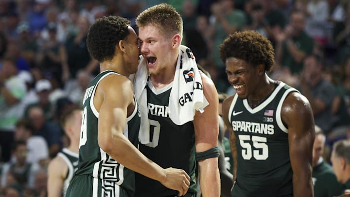 Nov 25, 2025; Fort Myers, Florida, USA; Michigan State Spartans forward Jaxon Kohler (0) reacts to guard Divine Ugochukwu (99) after a basket against the East Carolina Pirates in the first half at Suncoast Credit Union Arena. Mandatory Credit: Nathan Ray Seebeck-Imagn Images Nov 25, 2025; Fort Myers, Florida, USA; Michigan State Spartans forward Jaxon Kohler (0) reacts to guard Divine Ugochukwu (99) after a basket against the East Carolina Pirates in the first half at Suncoast Credit Union Arena. Mandatory Credit: Nathan Ray Seebeck-Imagn Images