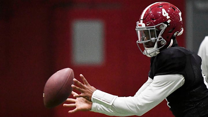 April 9, 2024; Tuscaloosa, Alabama, USA; Alabama quarterback Jalen Milroe (4) takes a snap during practice in the Hank Crisp Indoor Practice Facility at the University of Alabama.