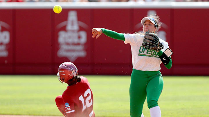 Oregon's Katie Flannery (6) attempts to turn a double play as Oklahoma's Maya Bland (12) slides into second in the seventh inning of the NCAA Norman Regional tournament softball final between the Oklahoma Sooners and the Oregon Ducks.
