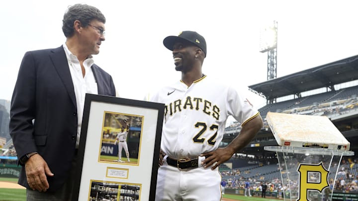 Jun 20, 2023; Pittsburgh, Pennsylvania, USA; Pittsburgh Pirates chairman Robert Nutting (left) presents designated hitter Andrew McCutchen (22) with a plaque and a base in commemoration of McCutchen's 2000th career MLB hit before the game against the Chicago Cubs at PNC Park. Mandatory Credit: Charles LeClaire-Imagn Images