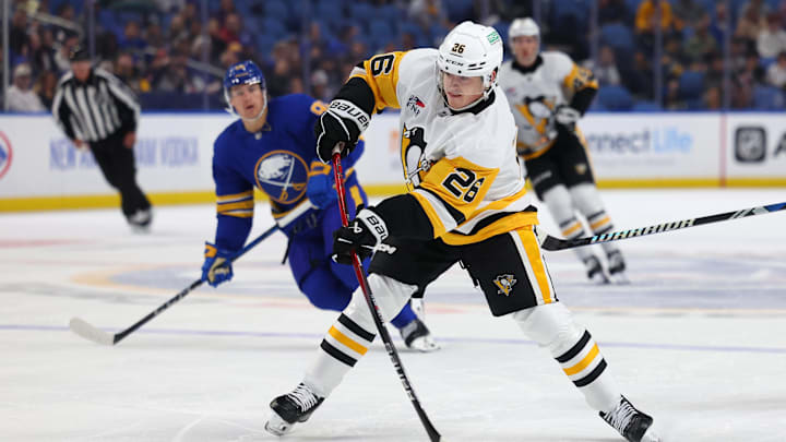 Sep 21, 2024; Buffalo, New York, USA;  Pittsburgh Penguins center Tristan Broz (26) takes a shot on goal during the first period against the Buffalo Sabres at KeyBank Center. Mandatory Credit: Timothy T. Ludwig-Imagn Images
