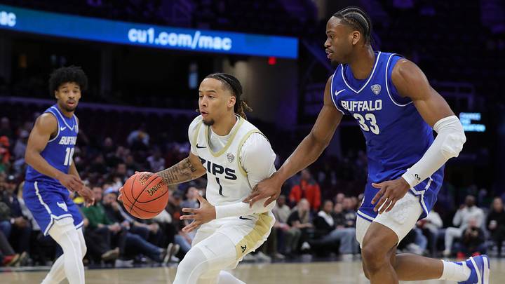 Buffalo Bulls center Tim Oboh (33) defends against Akron Zips guard Shammah Scott during the first half of MAC Basketball Tournament game at Rocket Arena. Buffalo Bulls center Tim Oboh (33) defends against Akron Zips guard Shammah Scott during the first half of MAC Basketball Tournament game at Rocket Arena.