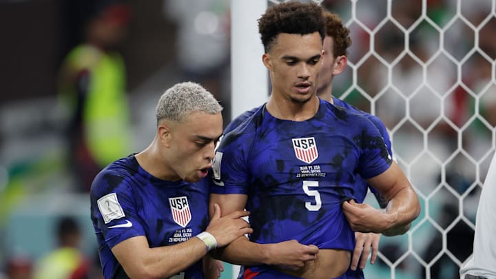 USMNT fullbacks Serginio Dest and Antonee Robinson talk during the USMNT's 1-0 win over Iran during the 2022 World Cup.