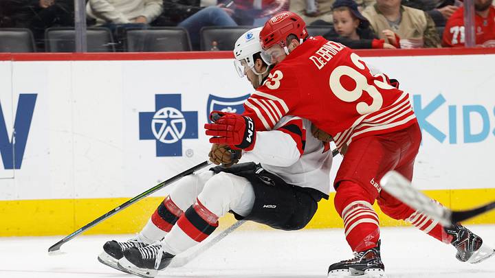 Apr 11, 2026; Detroit, Michigan, USA; New Jersey Devils center Nico Hischier (13) and Detroit Red Wings right wing Alex DeBrincat (93) battle for the puck in the third period at Little Caesars Arena. Mandatory Credit: Rick Osentoski-Imagn Images Apr 11, 2026; Detroit, Michigan, USA; New Jersey Devils center Nico Hischier (13) and Detroit Red Wings right wing Alex DeBrincat (93) battle for the puck in the third period at Little Caesars Arena. Mandatory Credit: Rick Osentoski-Imagn Images