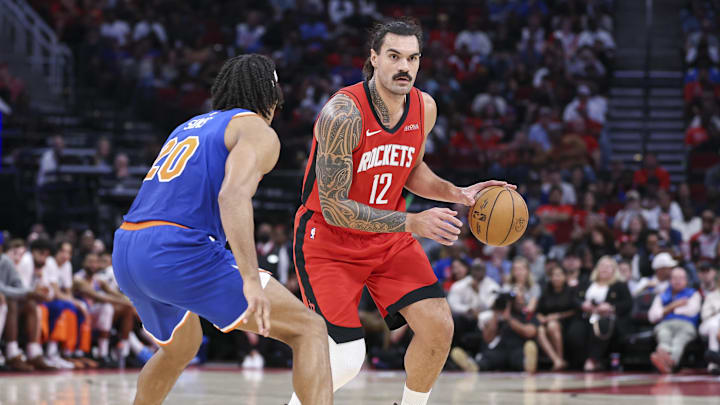Nov 4, 2024; Houston, Texas, USA; Houston Rockets center Steven Adams (12) dribbles the ball as New York Knicks center Jericho Sims (20) defends during the game at Toyota Center. Mandatory Credit: Troy Taormina-Imagn Images Nov 4, 2024; Houston, Texas, USA; Houston Rockets center Steven Adams (12) dribbles the ball as New York Knicks center Jericho Sims (20) defends during the game at Toyota Center. Mandatory Credit: Troy Taormina-Imagn Images