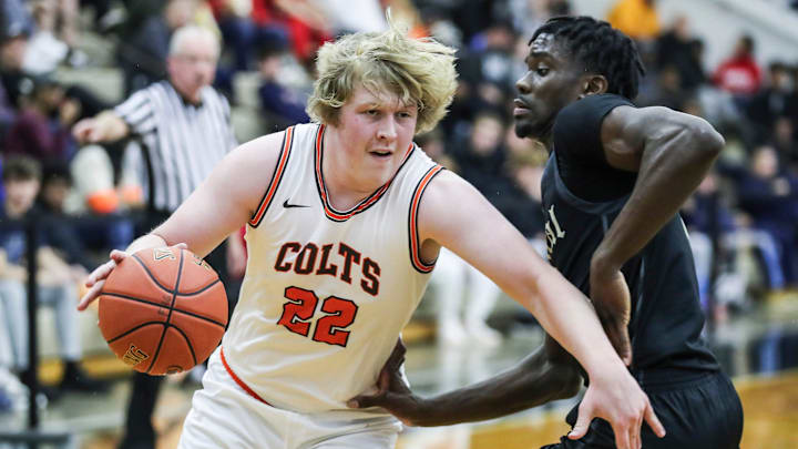 DeSale's William Gibson (22) drives on Little Rock Central's Annor Boateng (12) at Thursday's 2023 Chad Gardner Law King of the Bluegrass holiday basketball tournament at Fairdale High School. Dec. 21, 2023