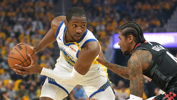 Apr 26, 2025; San Francisco, California, USA; Golden State Warriors forward Jonathan Kuminga (left) handles the ball against Houston Rockets guard Jalen Green (right) during the first quarter of game three of first round for the 2024 NBA Playoffs at Chase Center. Mandatory Credit: Darren Yamashita-Imagn Images